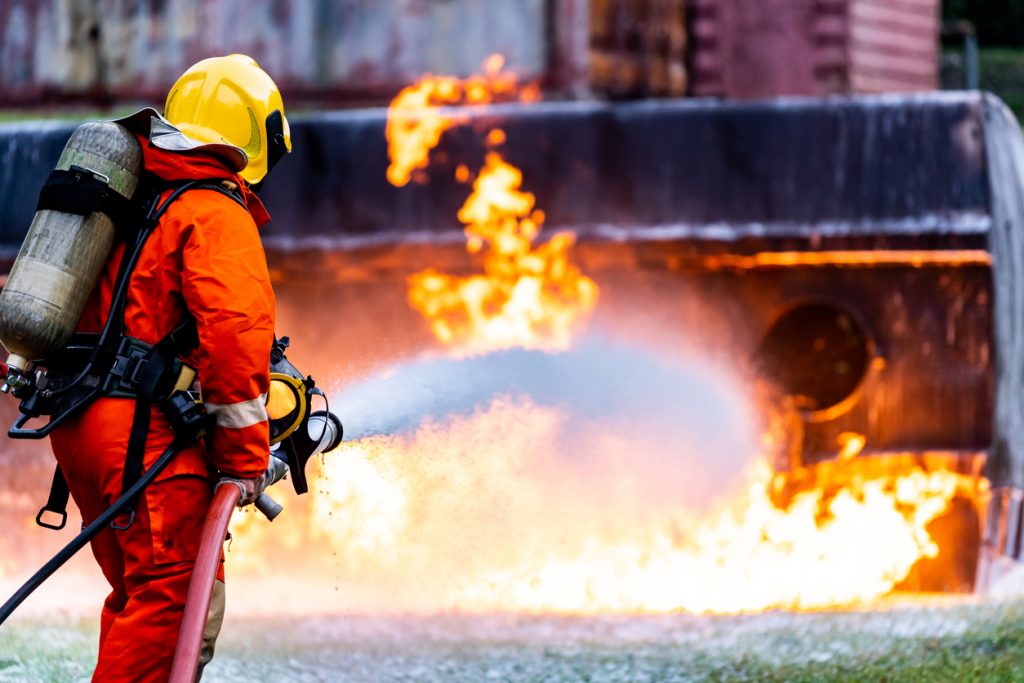 semi-truck blaze and firefighter